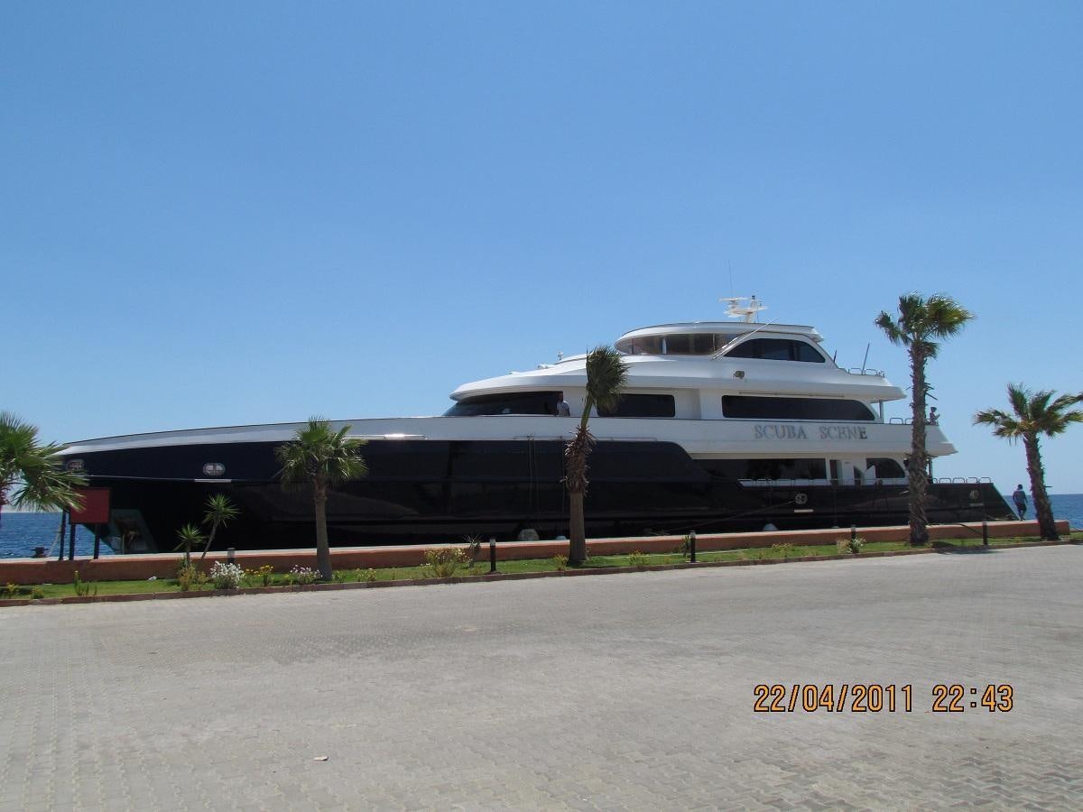 a white yacht parked on the side of a road aboard SCUBA SCENE Yacht for Sale
