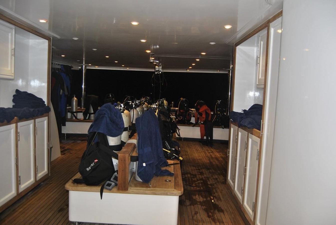 a room with clothes on the swinger aboard SCUBA SCENE Yacht for Sale