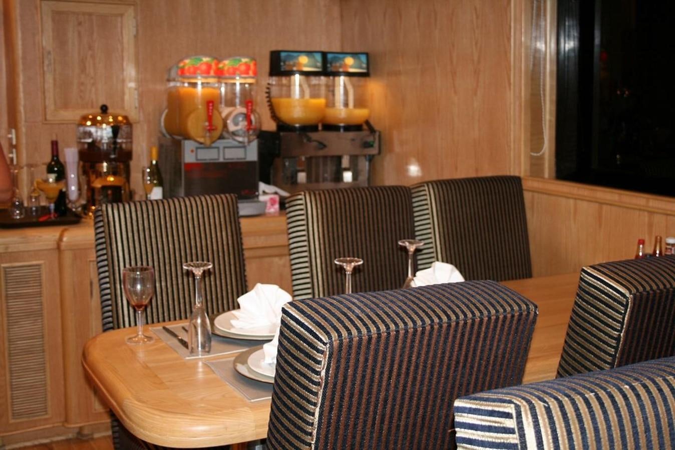 a restaurant with a table and chairs aboard SCUBA SCENE Yacht for Sale