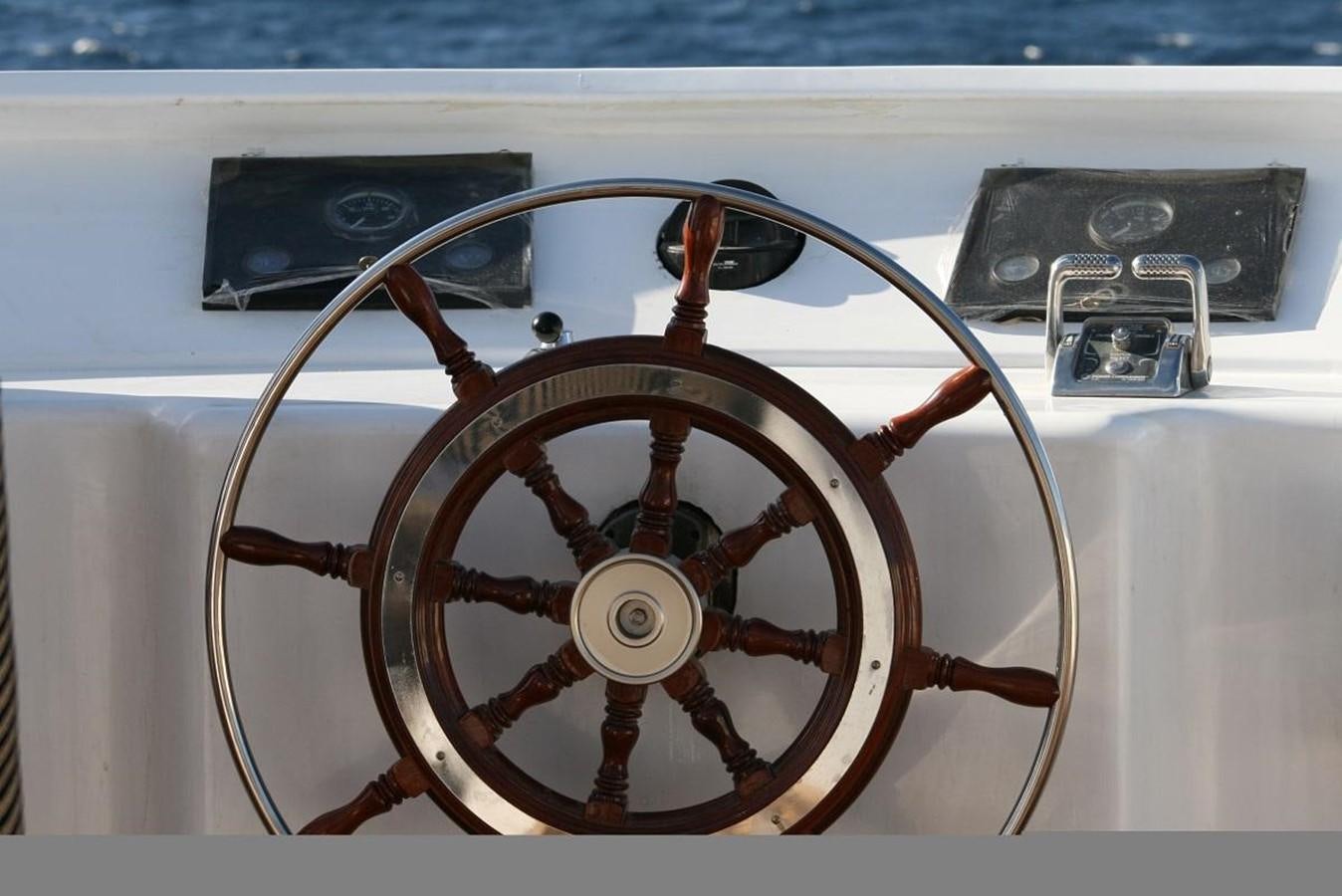 a steering wheel with a wood steering wheel aboard SCUBA SCENE Yacht for Sale