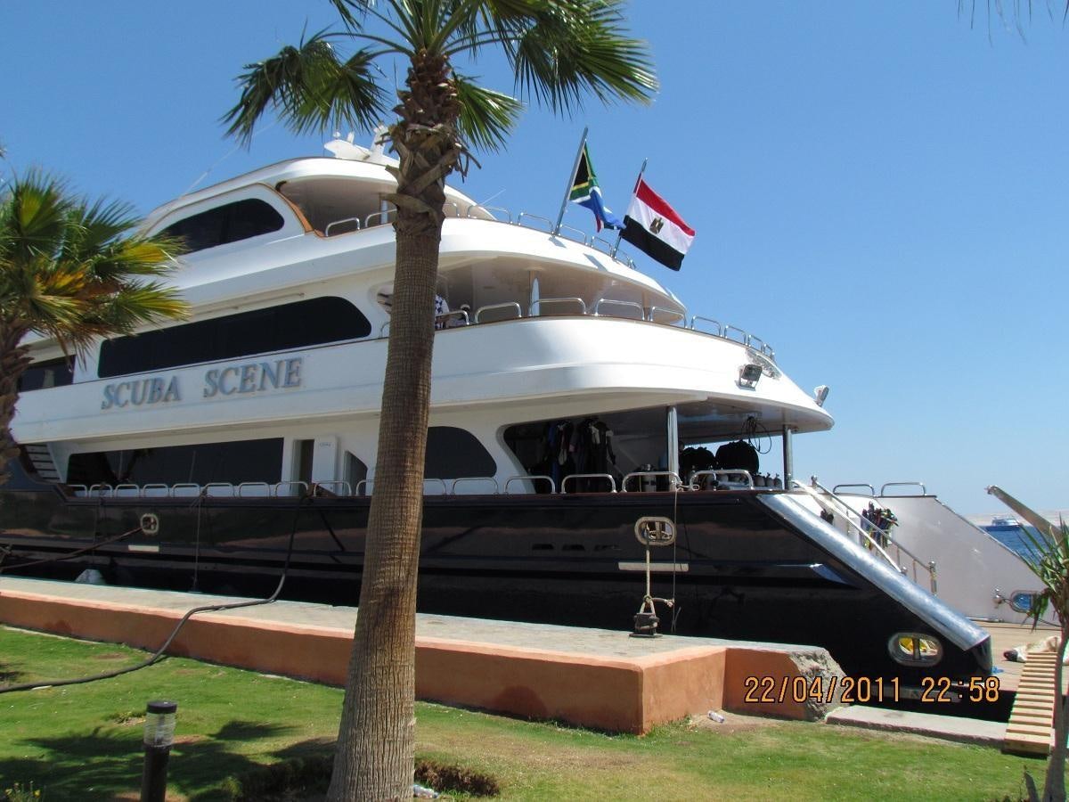 a boat with a flag on the front aboard SCUBA SCENE Yacht for Sale