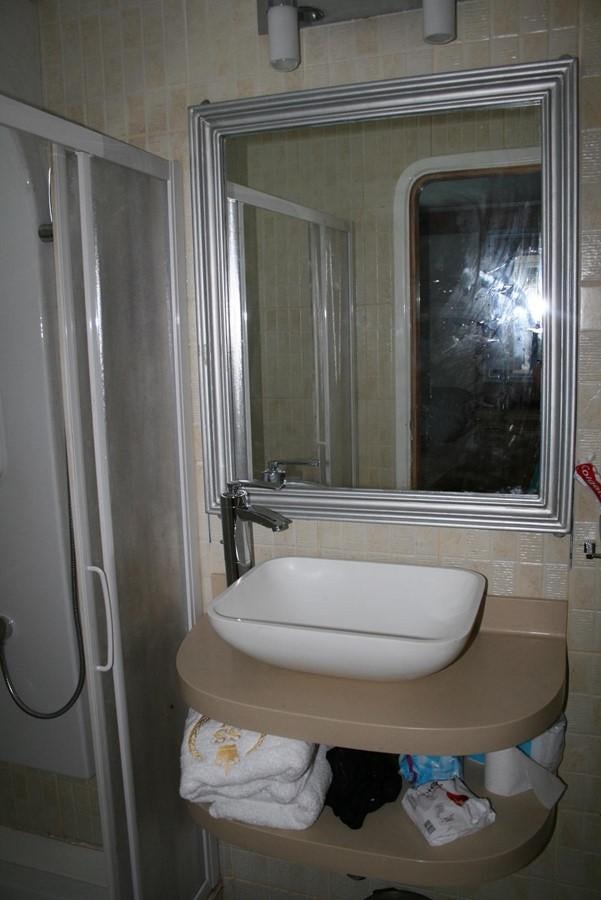 a bathroom with a mirror and sink aboard SCUBA SCENE Yacht for Sale