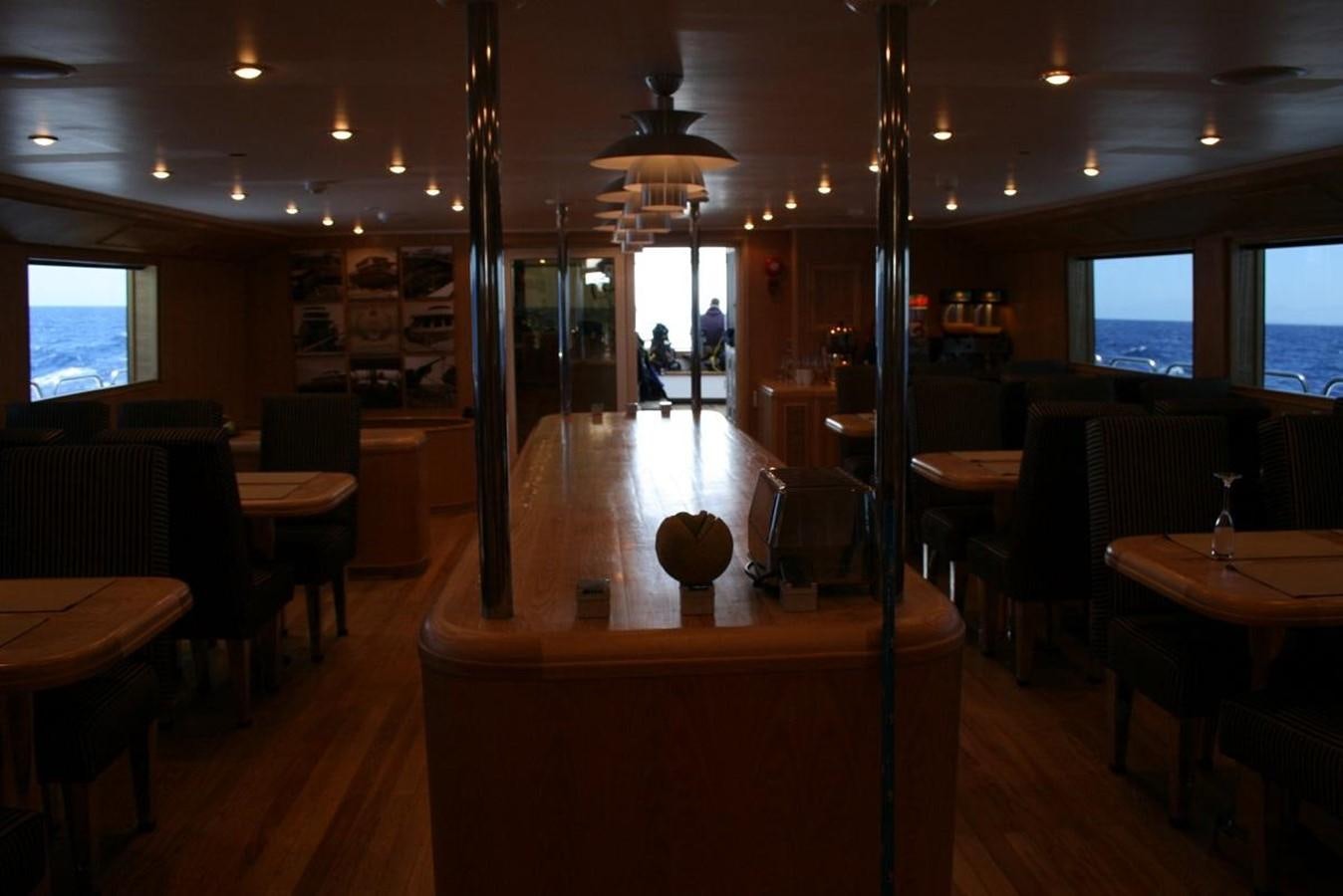 a restaurant with tables and chairs aboard SCUBA SCENE Yacht for Sale