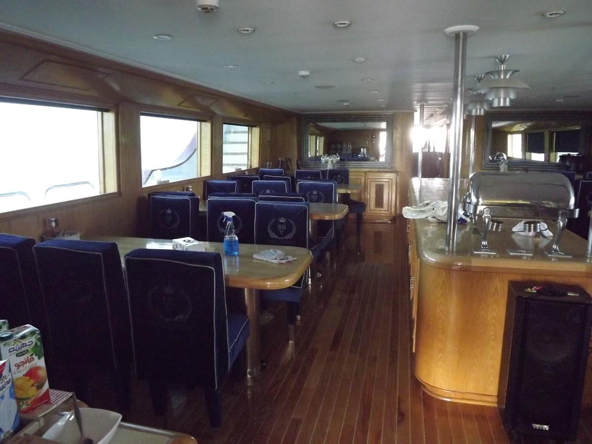 a room with tables and chairs aboard SCUBA SCENE Yacht for Sale