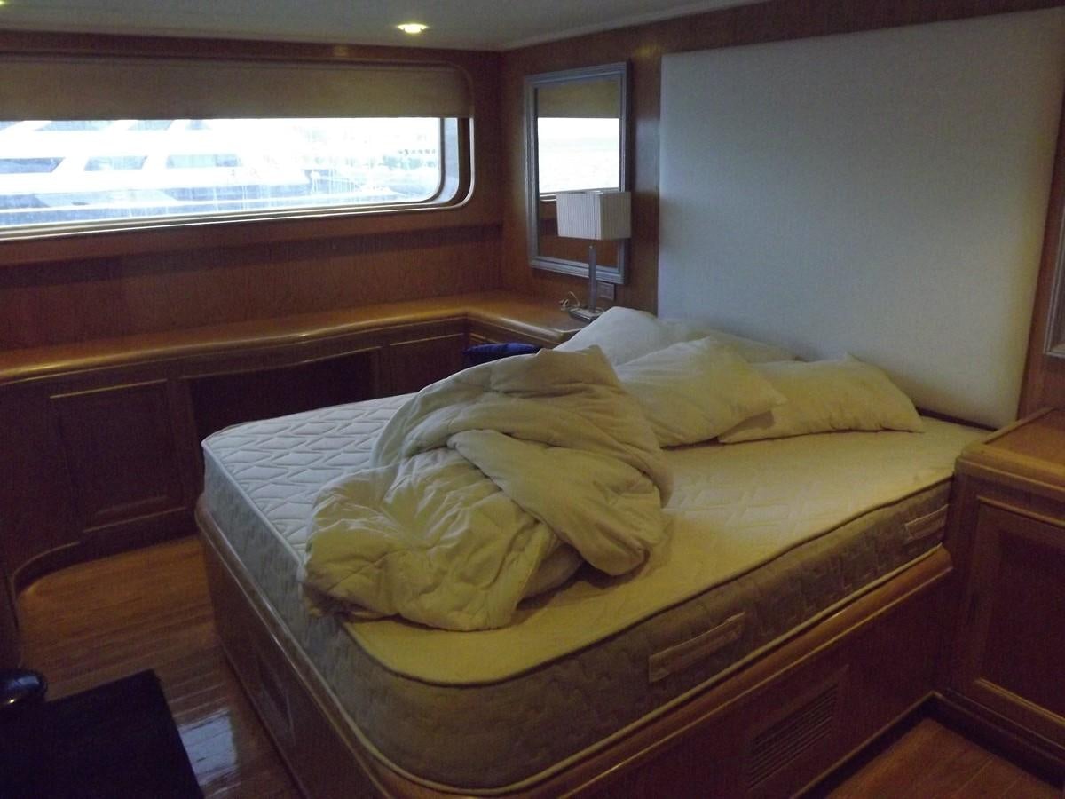 a bed with a blanket on it aboard SCUBA SCENE Yacht for Sale