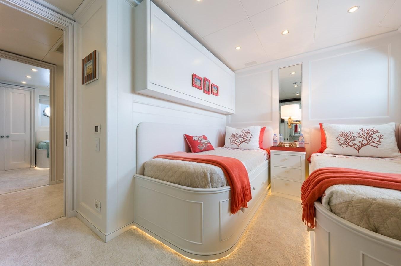 a room with a bed and a chair aboard BINA Yacht for Sale