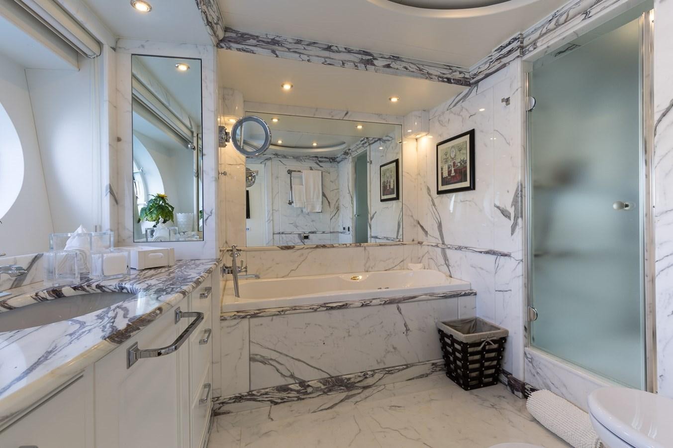 a bathroom with a tub sink and a mirror aboard BINA Yacht for Sale