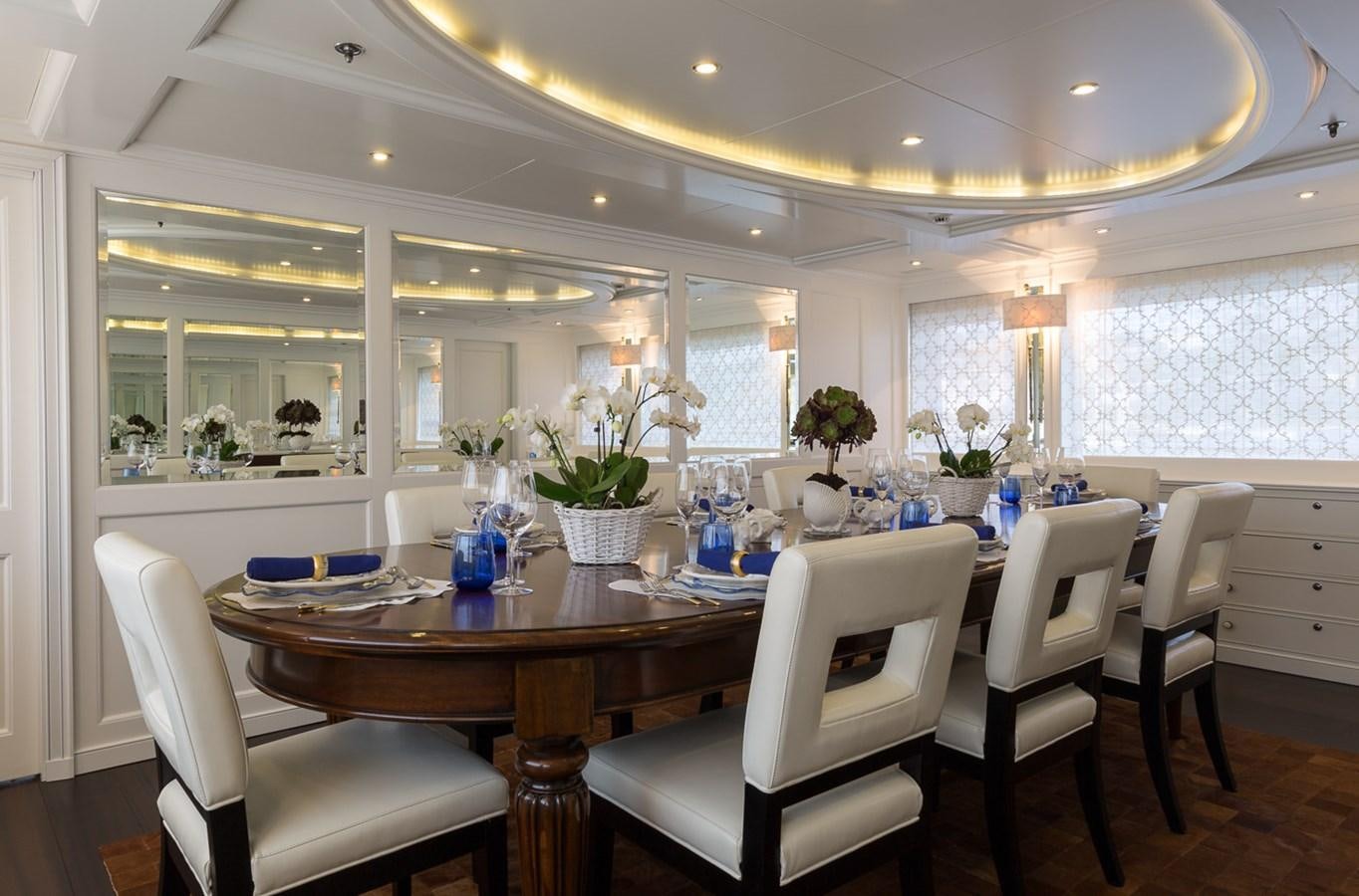 a large kitchen with a table and chairs aboard BINA Yacht for Sale