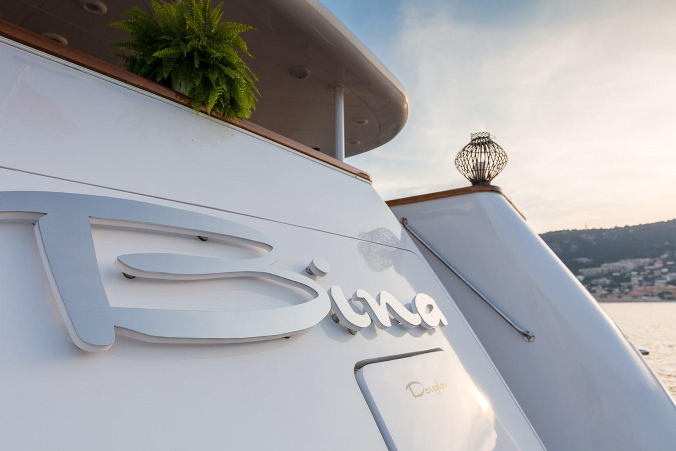 a white boat on a beach aboard BINA Yacht for Sale