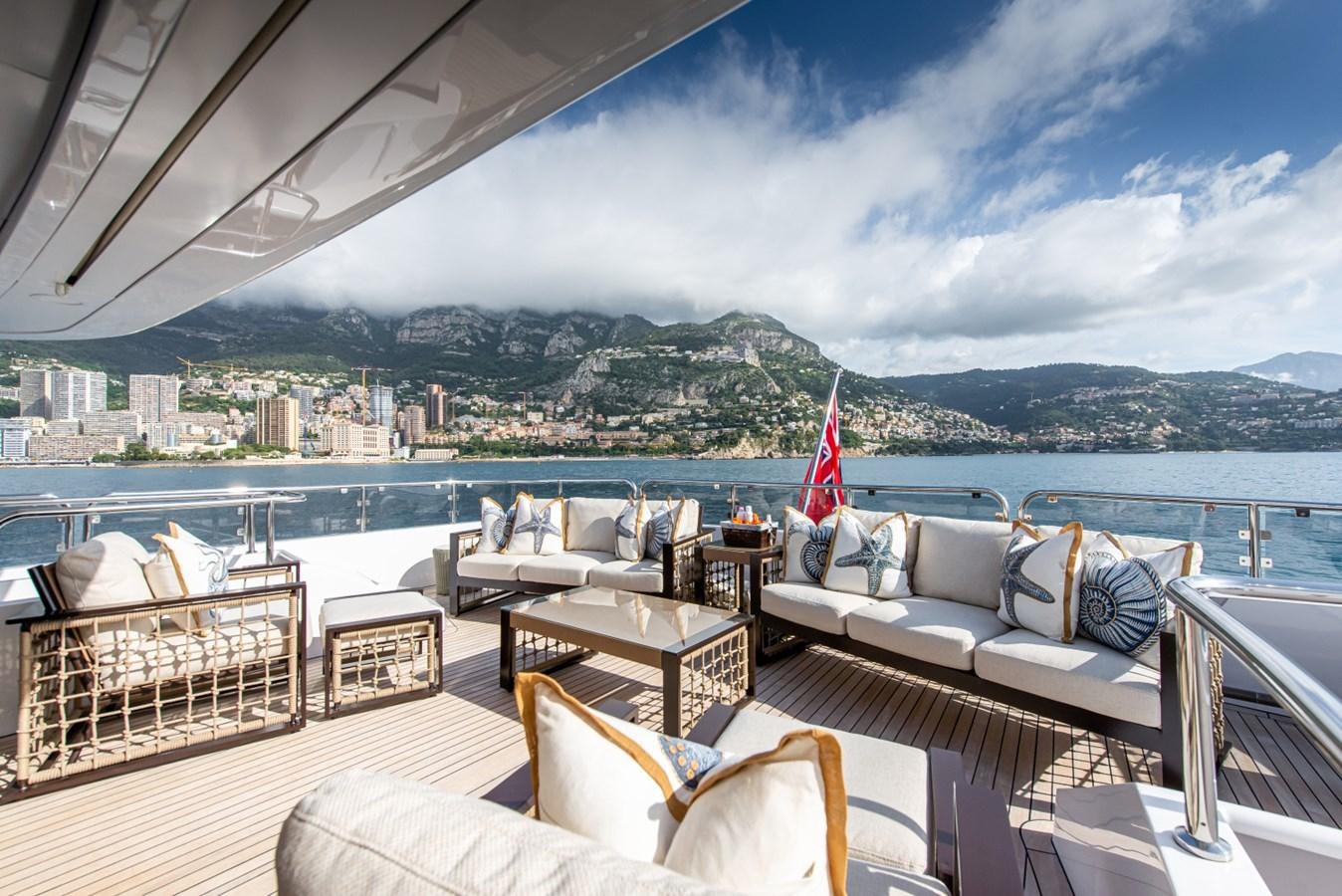 a large room with a view of a city and a body of water aboard BINA Yacht for Sale