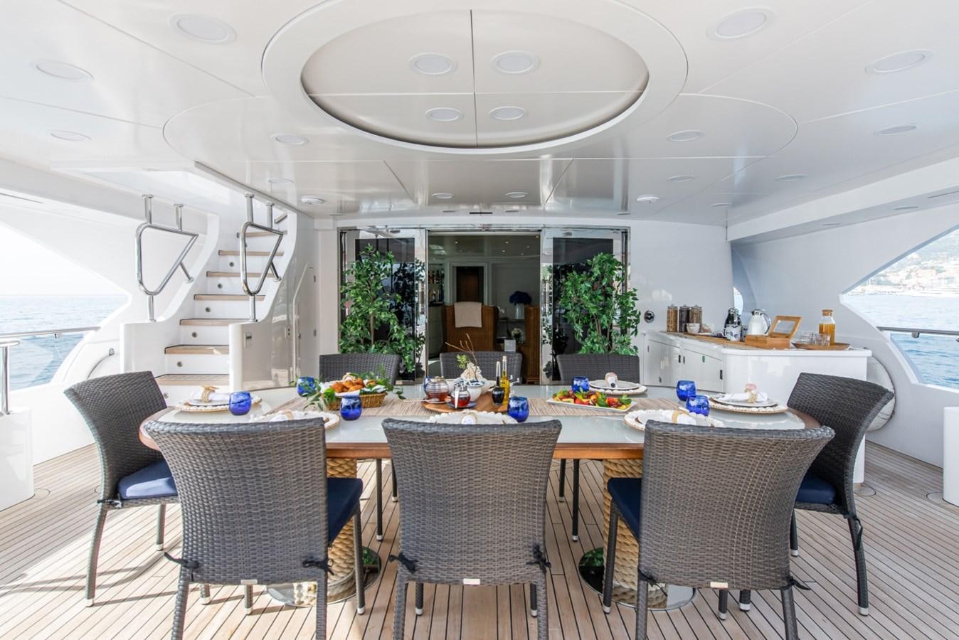 a dining room with a table and chairs aboard BINA Yacht for Sale
