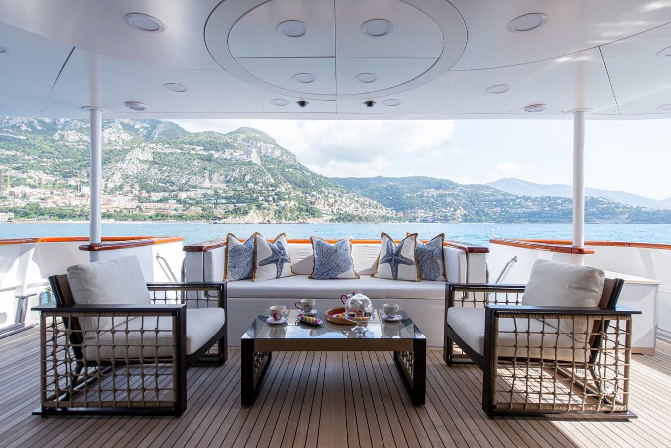 a room with a table and chairs aboard BINA Yacht for Sale