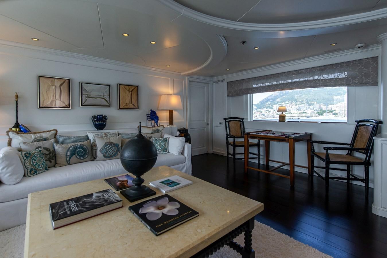 a living room with a large window aboard BINA Yacht for Sale