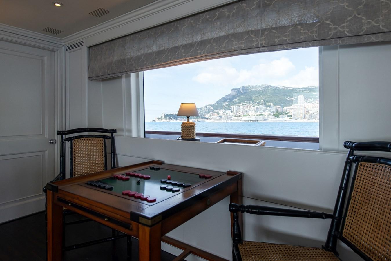 a table with a lamp on it aboard BINA Yacht for Sale