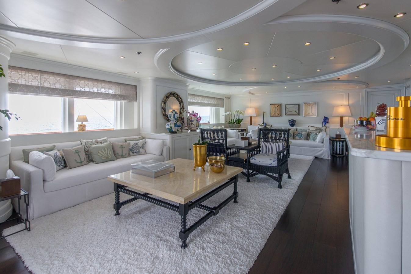 a living room with a white couch and a coffee table aboard BINA Yacht for Sale