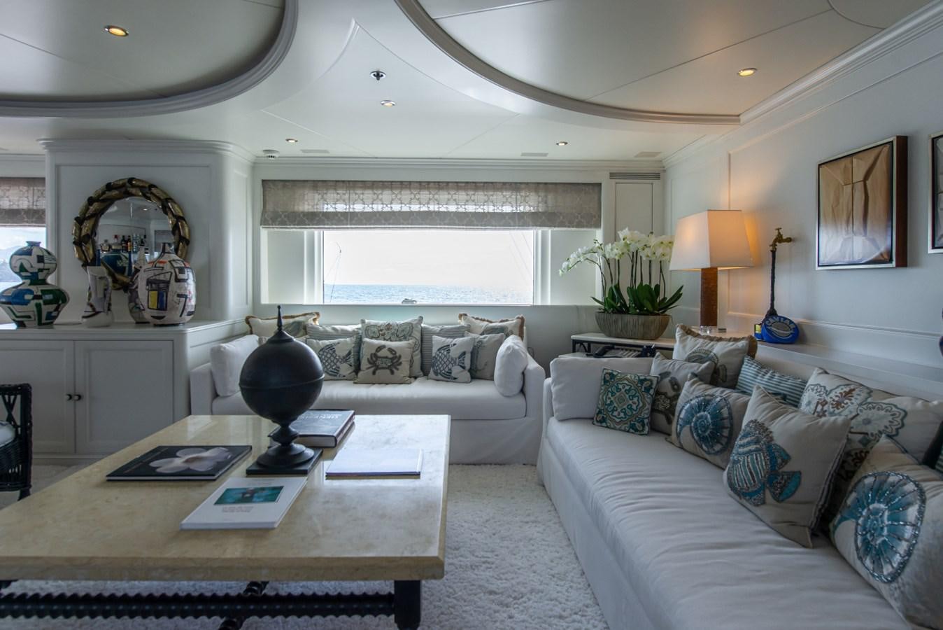 a living room with a couch and a coffee table aboard BINA Yacht for Sale
