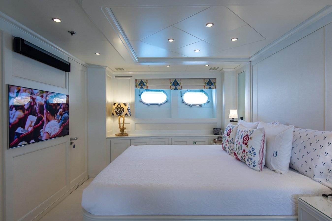 a bed with white sheets and pillows aboard BINA Yacht for Sale