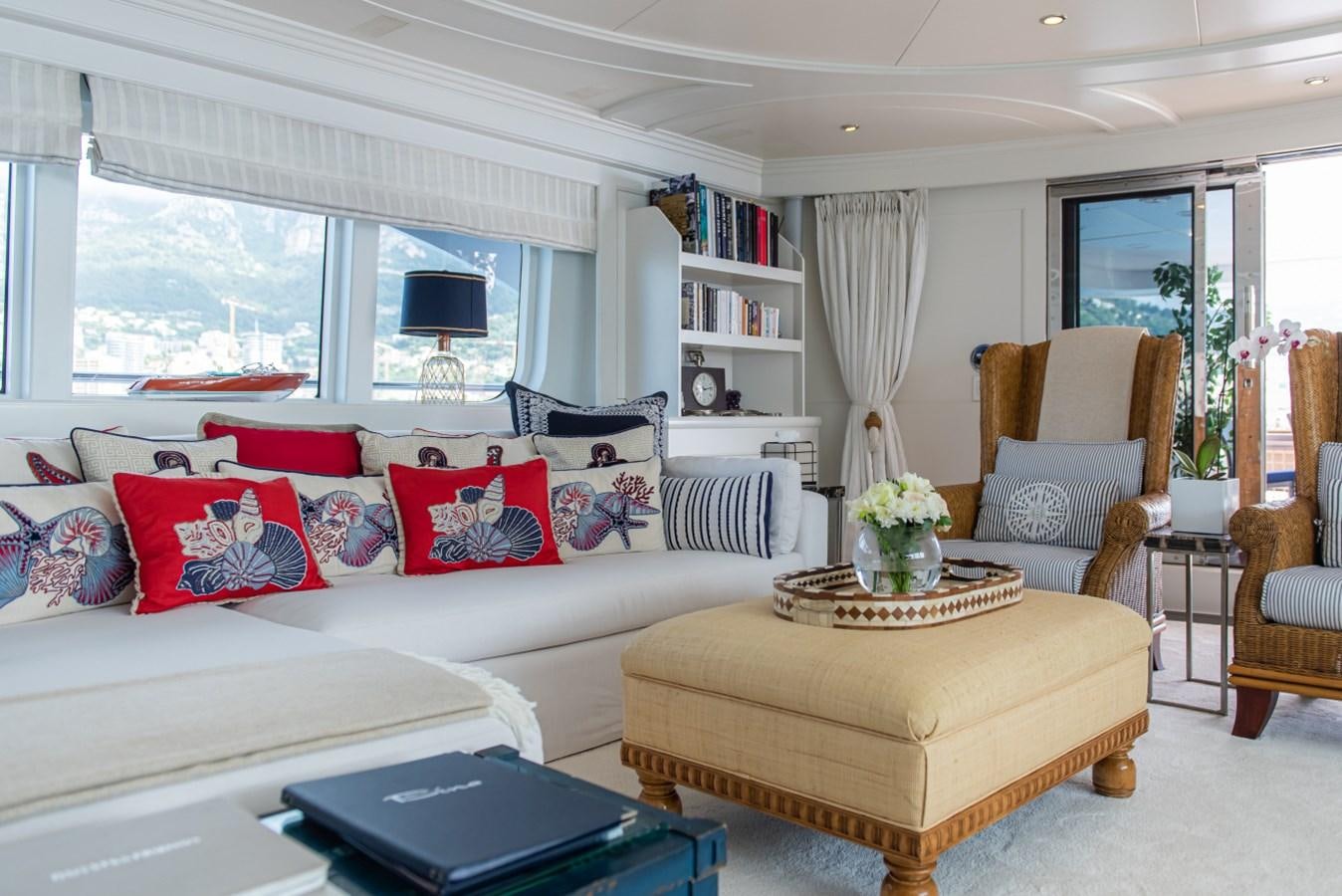 a living room with a couch and a table aboard BINA Yacht for Sale