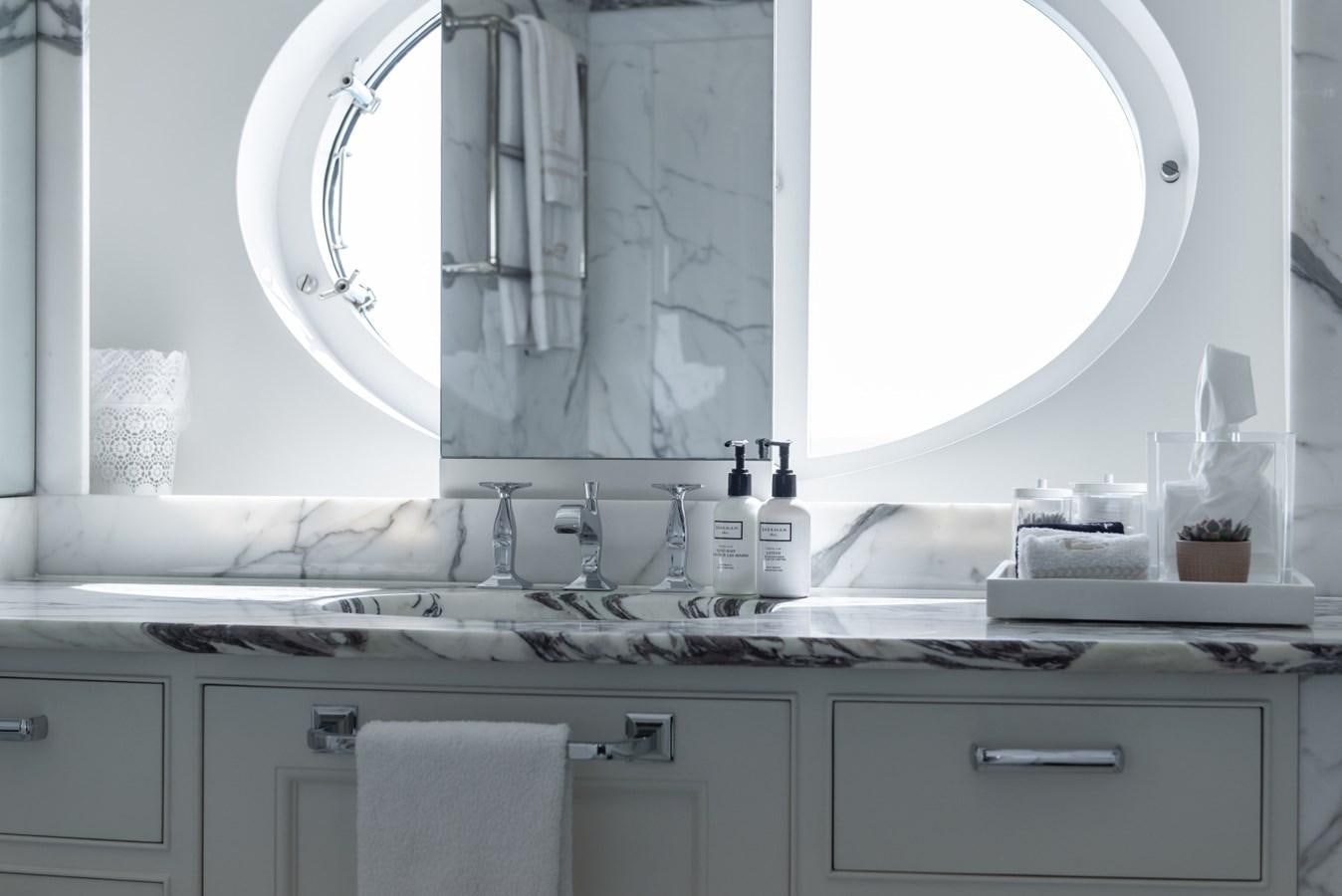 a bathroom with a large mirror aboard BINA Yacht for Sale