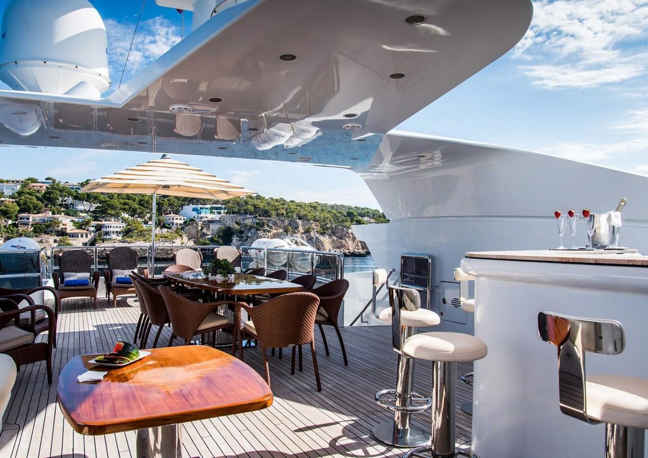 a patio with tables and chairs aboard DIANE Yacht for Sale