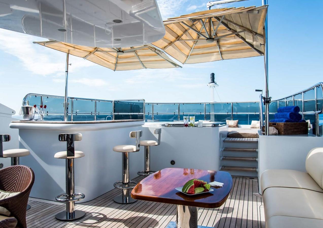 a table and chairs on a patio aboard DIANE Yacht for Sale