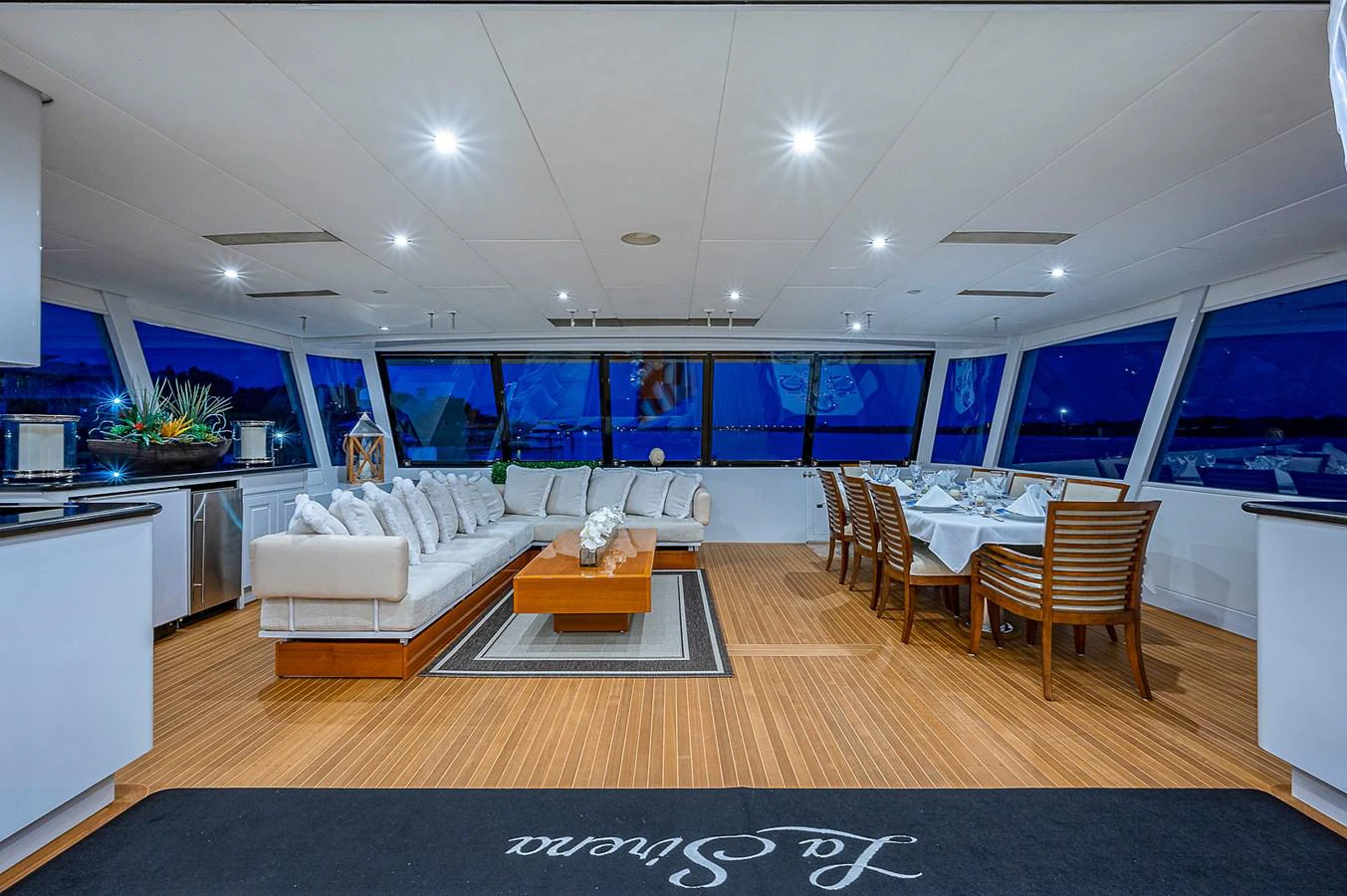 a large living room with a large screen aboard LA SIRENA Yacht for Sale