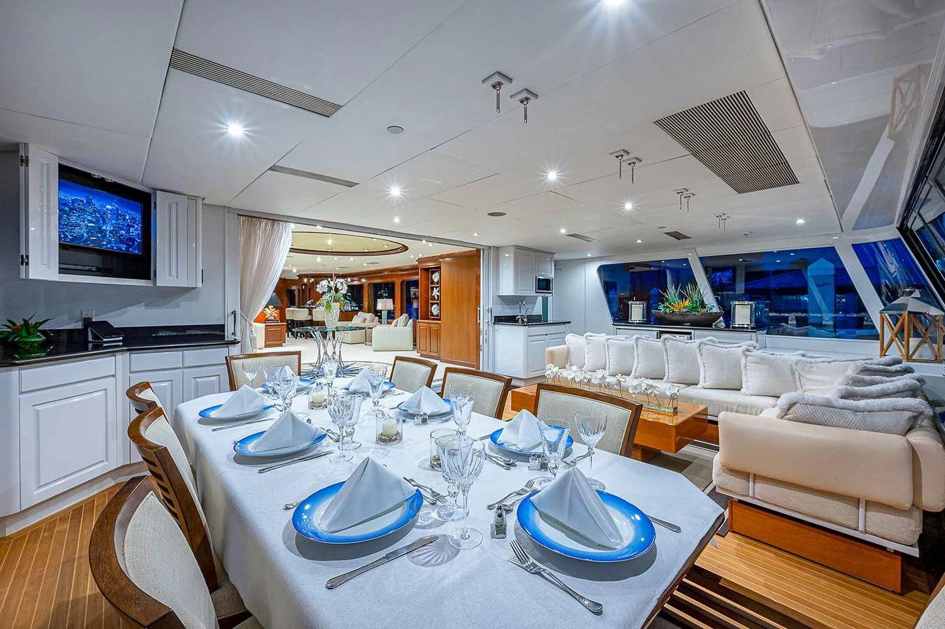 a dining room with white chairs and white cabinets aboard LA SIRENA Yacht for Sale