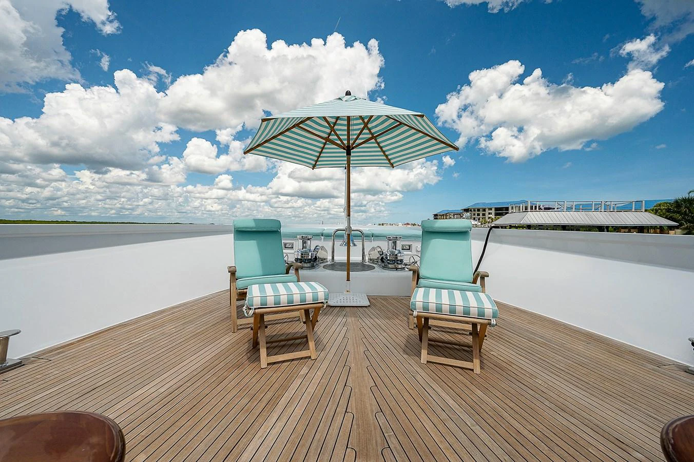 a deck with chairs and an umbrella aboard LA SIRENA Yacht for Sale