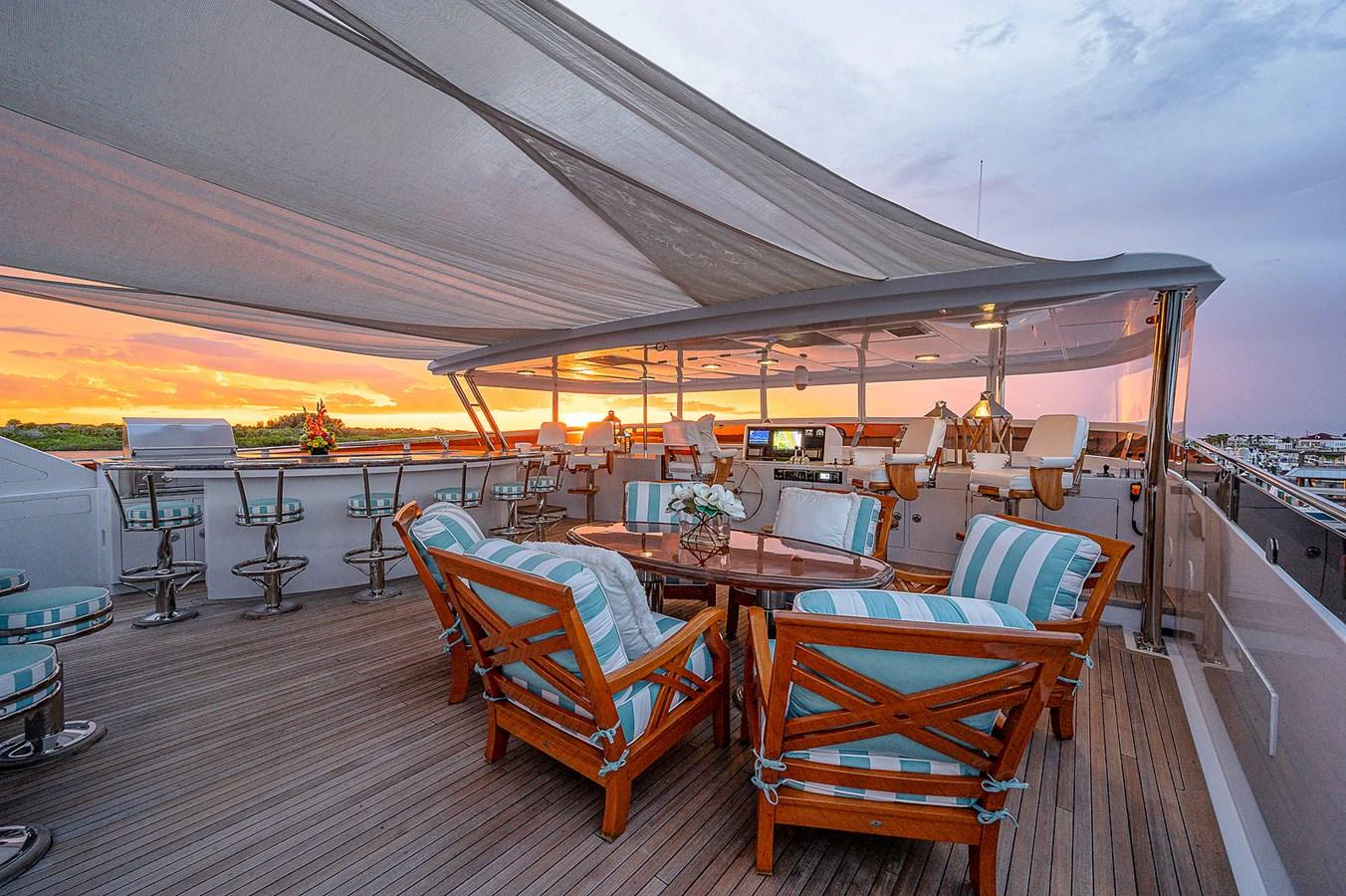 a deck with tables and chairs aboard LA SIRENA Yacht for Sale
