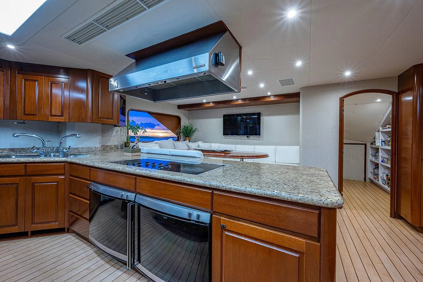 a kitchen with wooden cabinets aboard LA SIRENA Yacht for Sale