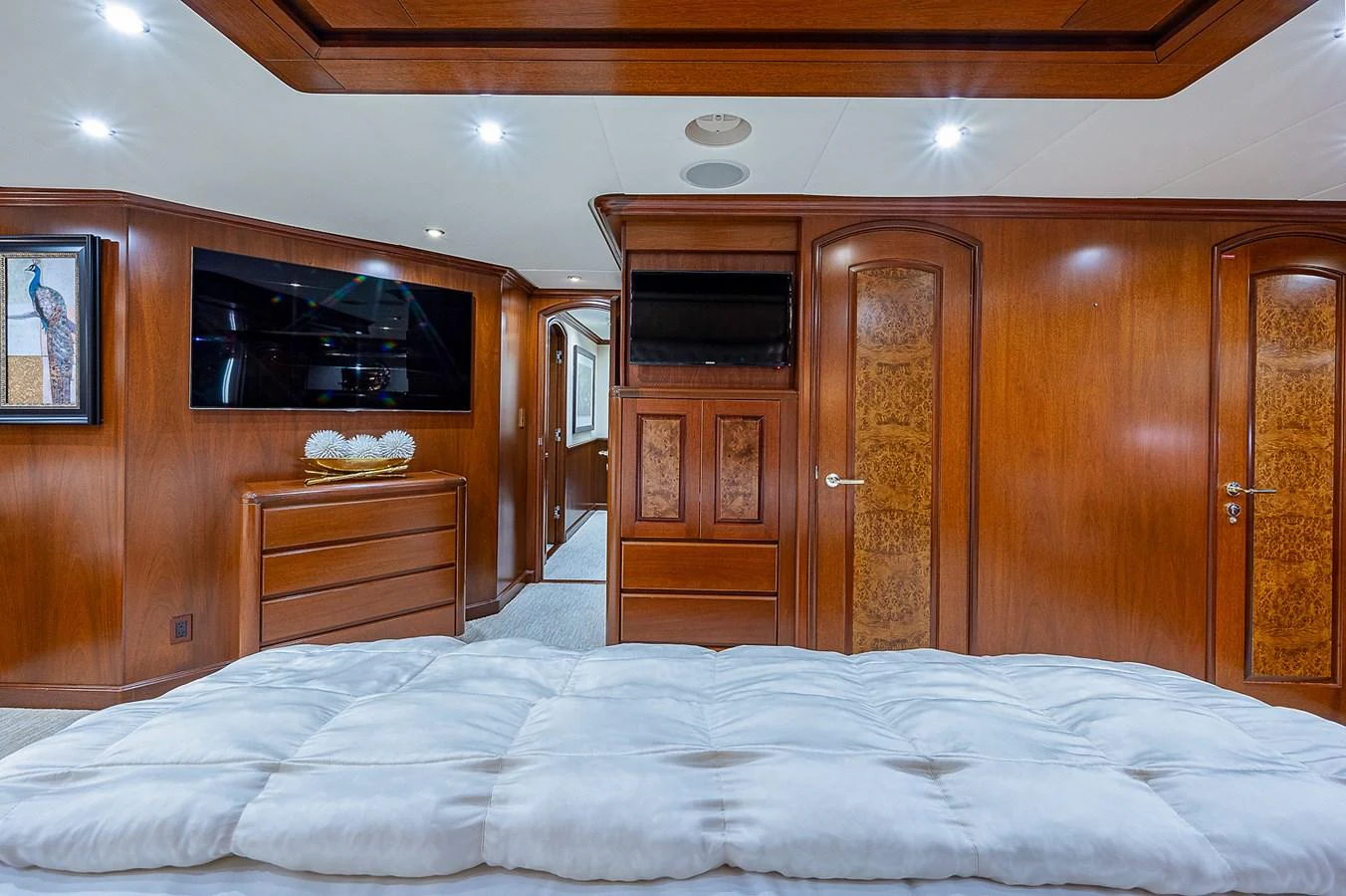 a bedroom with wooden cabinets aboard LA SIRENA Yacht for Sale