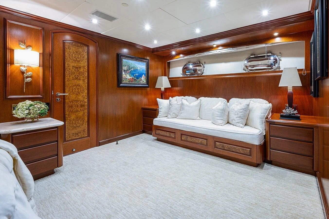 a bedroom with a bed and a wood cabinet aboard LA SIRENA Yacht for Sale