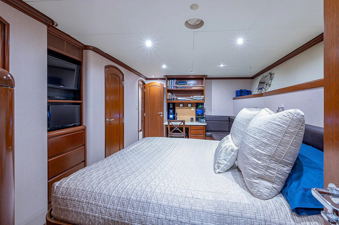 a bedroom with a bed and a television aboard LA SIRENA Yacht for Sale