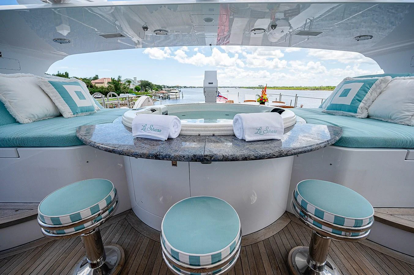 a room with a pool and a table with chairs aboard LA SIRENA Yacht for Sale