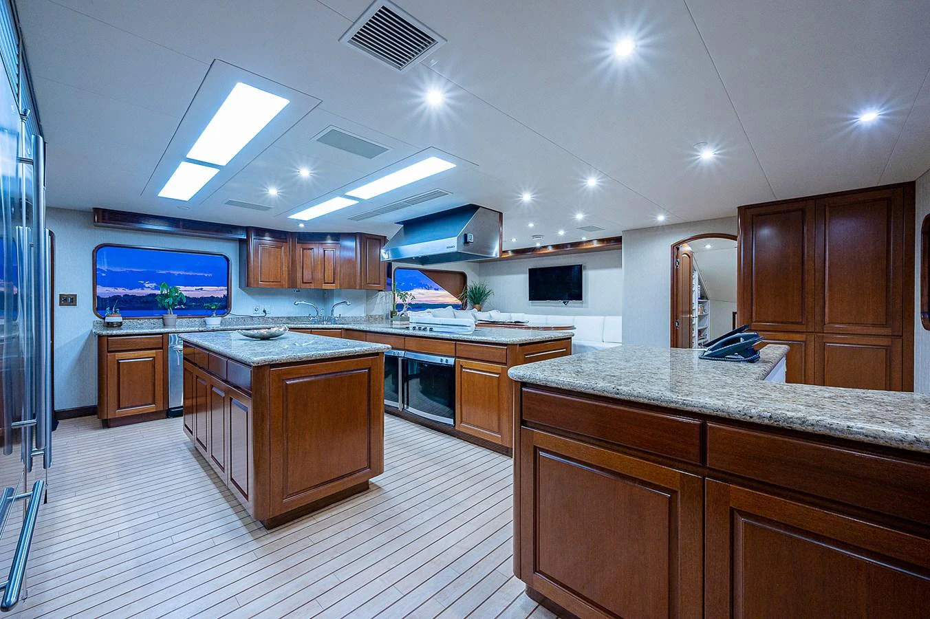 a large kitchen with wooden cabinets aboard LA SIRENA Yacht for Sale
