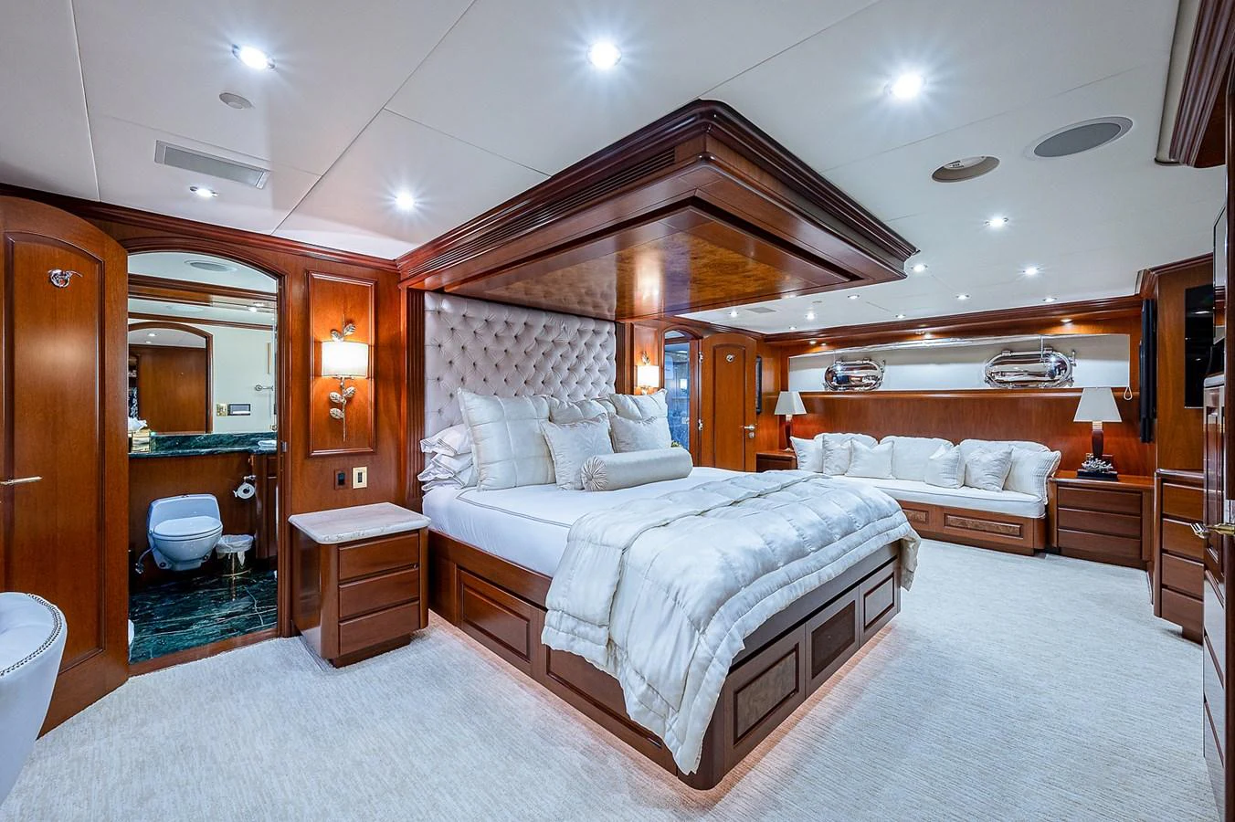 a large bedroom with a bed and a mirror aboard LA SIRENA Yacht for Sale