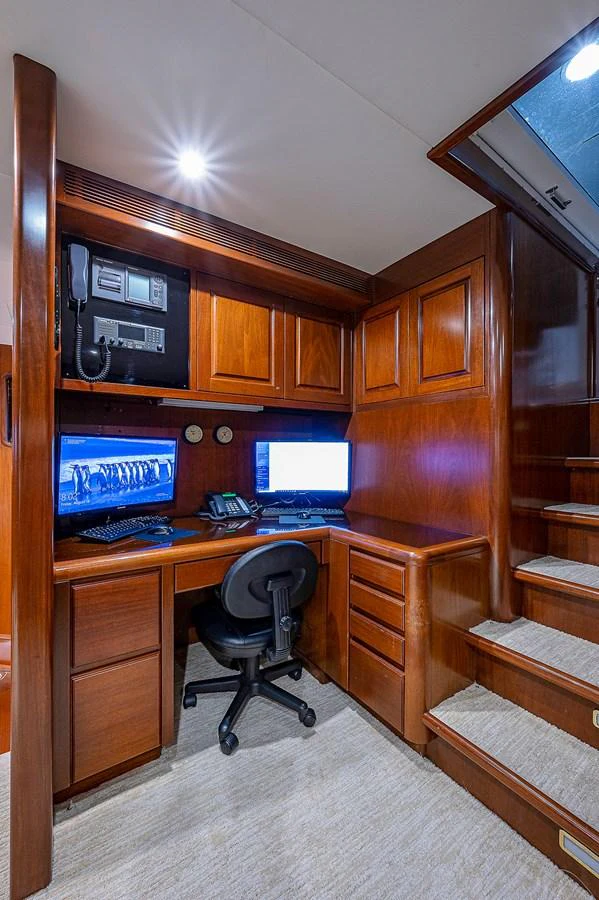 a computer desk with a chair and a computer on it aboard LA SIRENA Yacht for Sale