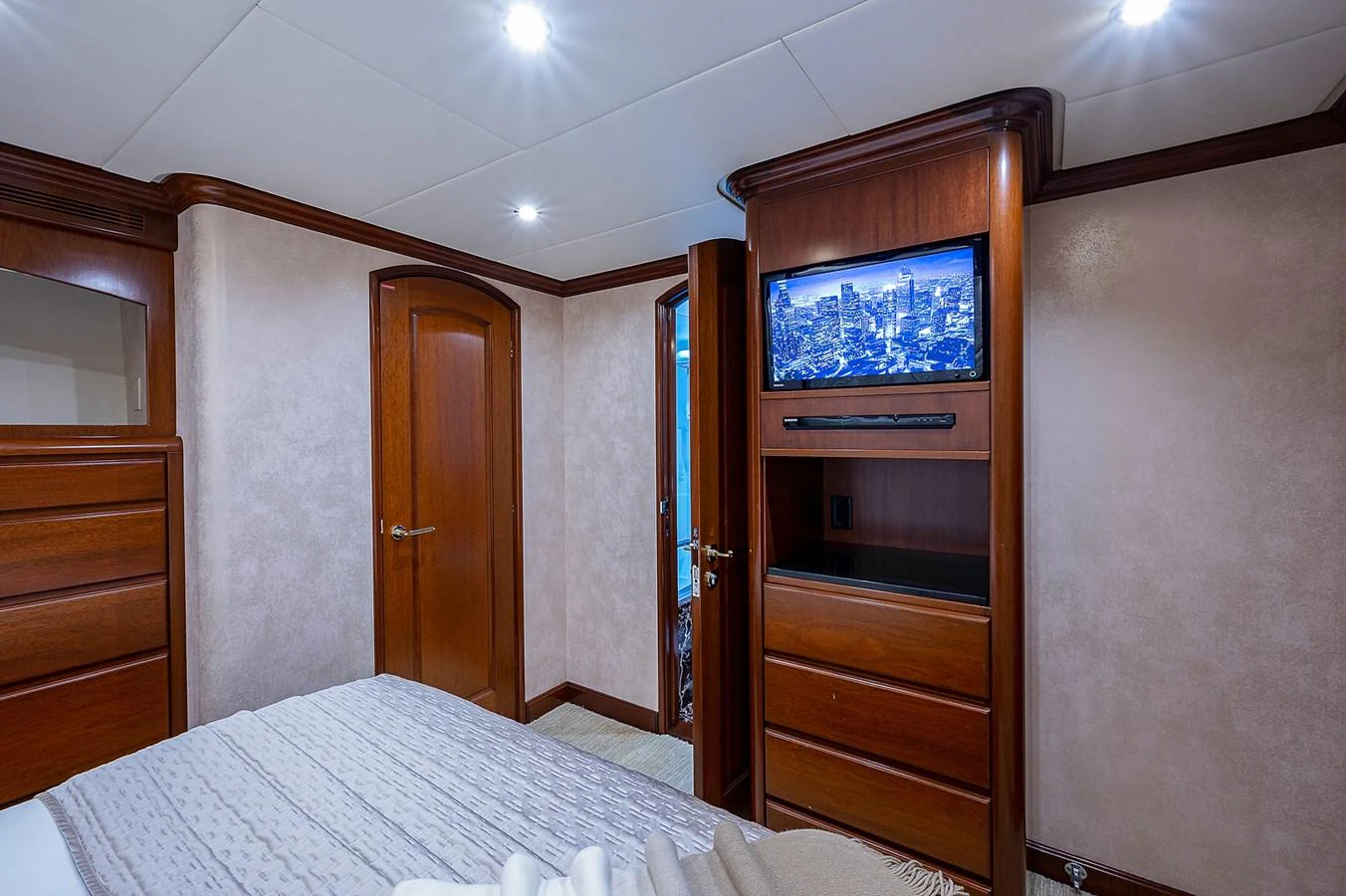 a bedroom with a television on the wall aboard LA SIRENA Yacht for Sale