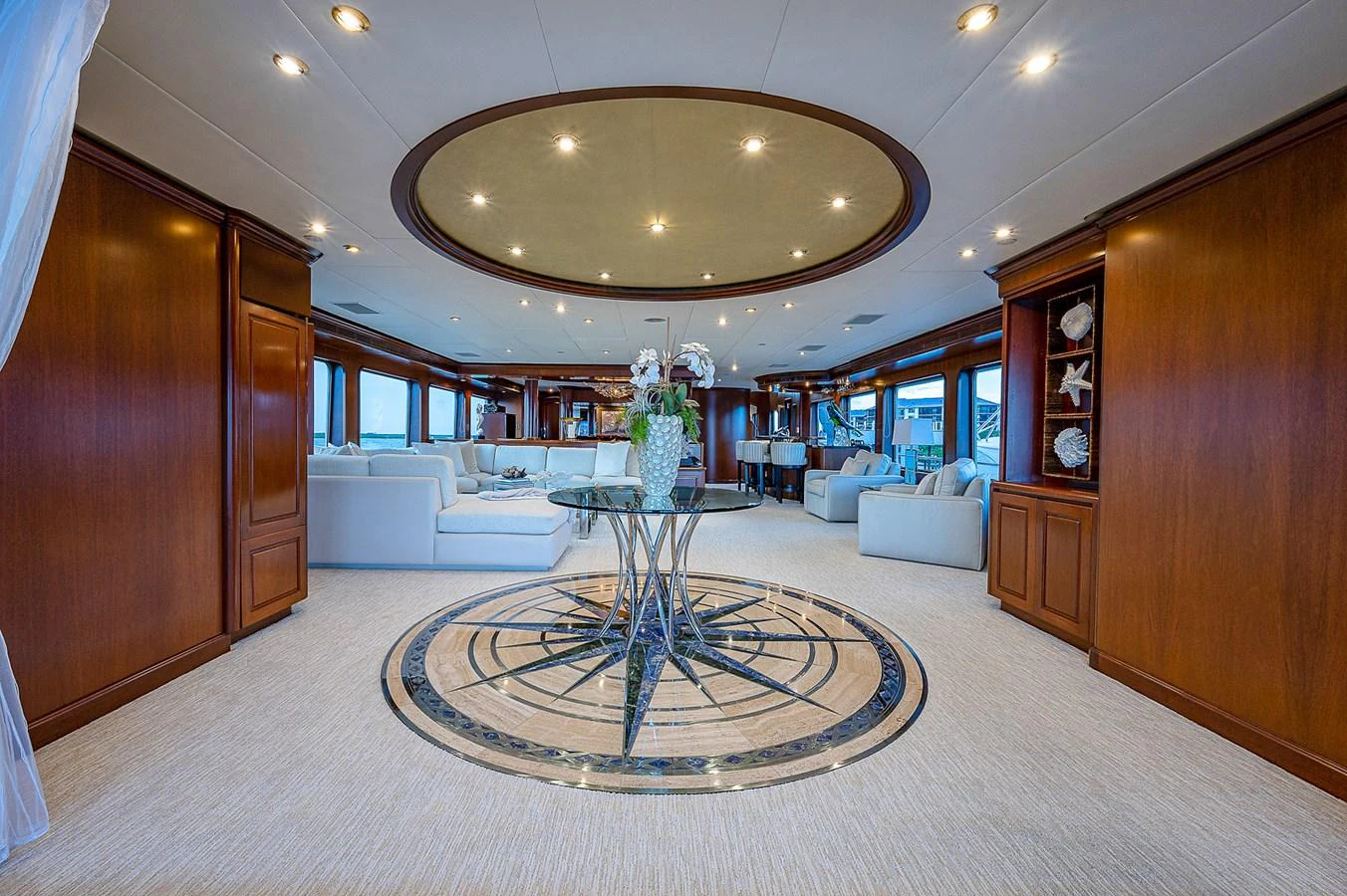 a large room with a round table and a chandelier aboard LA SIRENA Yacht for Sale
