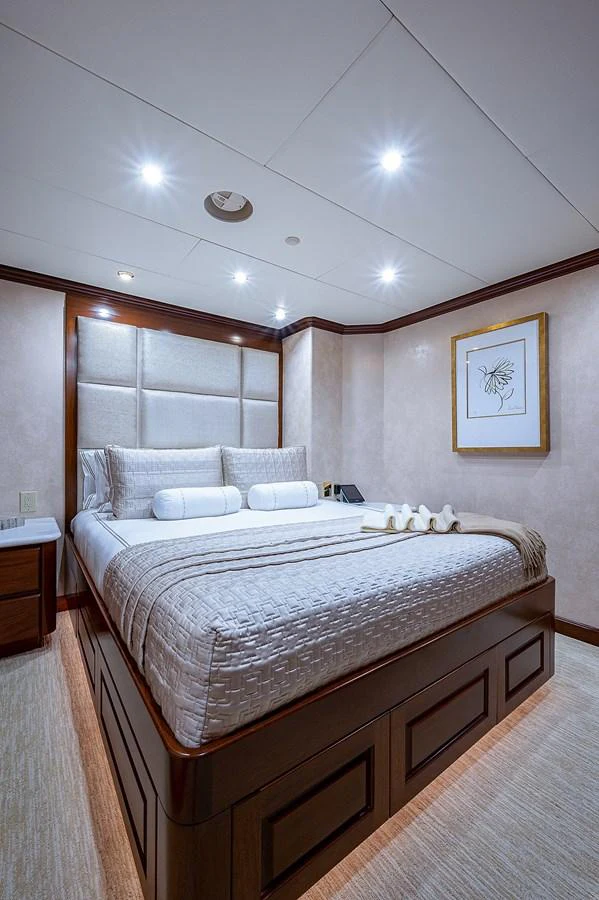 a bed with a white comforter aboard LA SIRENA Yacht for Sale