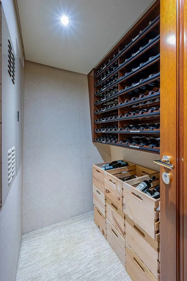 a room with a bed and a dresser aboard LA SIRENA Yacht for Sale