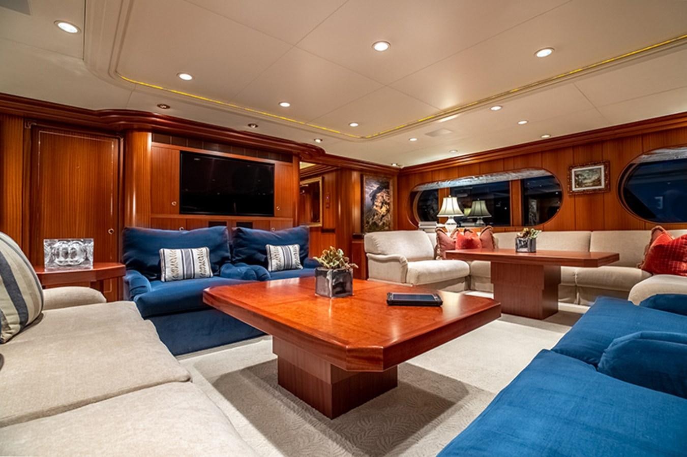 a living room with a table and couches aboard NEVER ENOUGH Yacht for Sale
