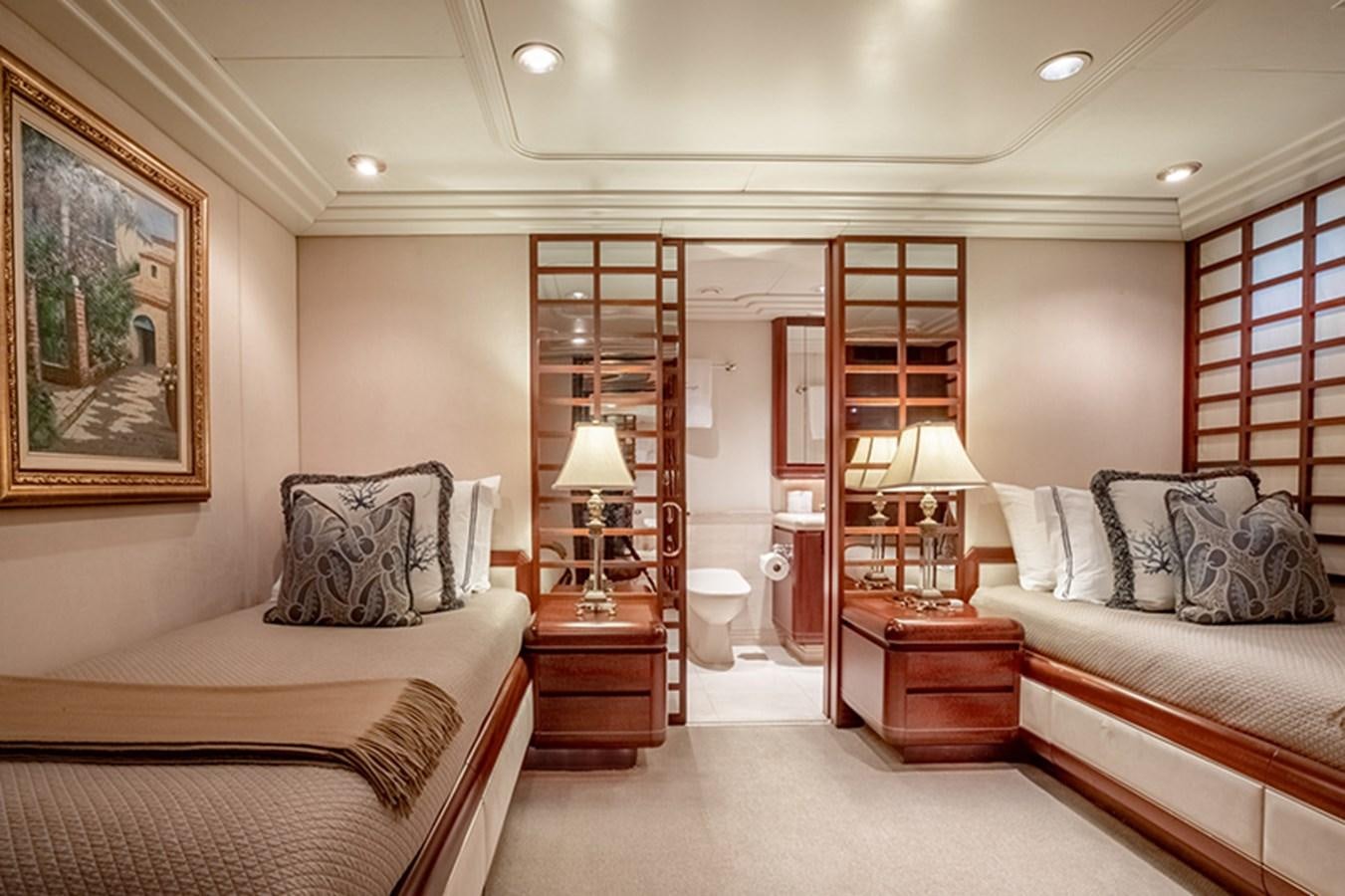 a bedroom with a bed and a desk aboard NEVER ENOUGH Yacht for Sale
