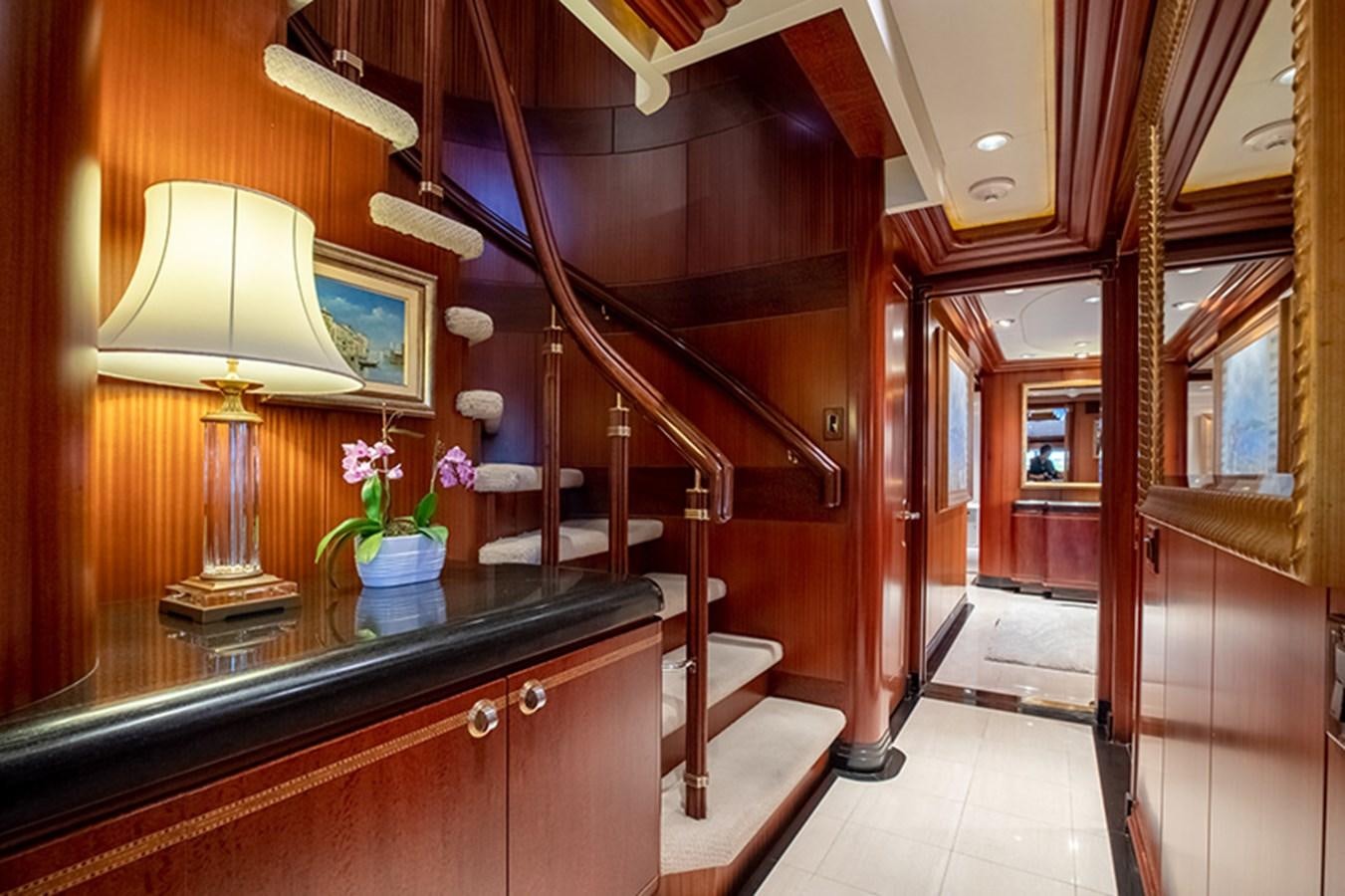 a room with a lamp and a staircase aboard NEVER ENOUGH Yacht for Sale