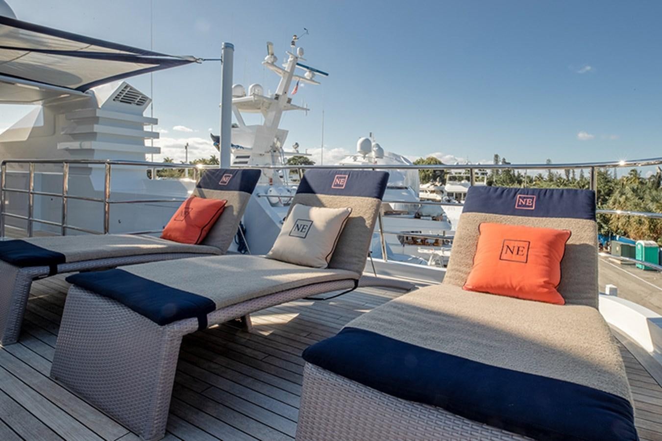 a deck with a large deck and a large wind turbine in the background aboard NEVER ENOUGH Yacht for Sale