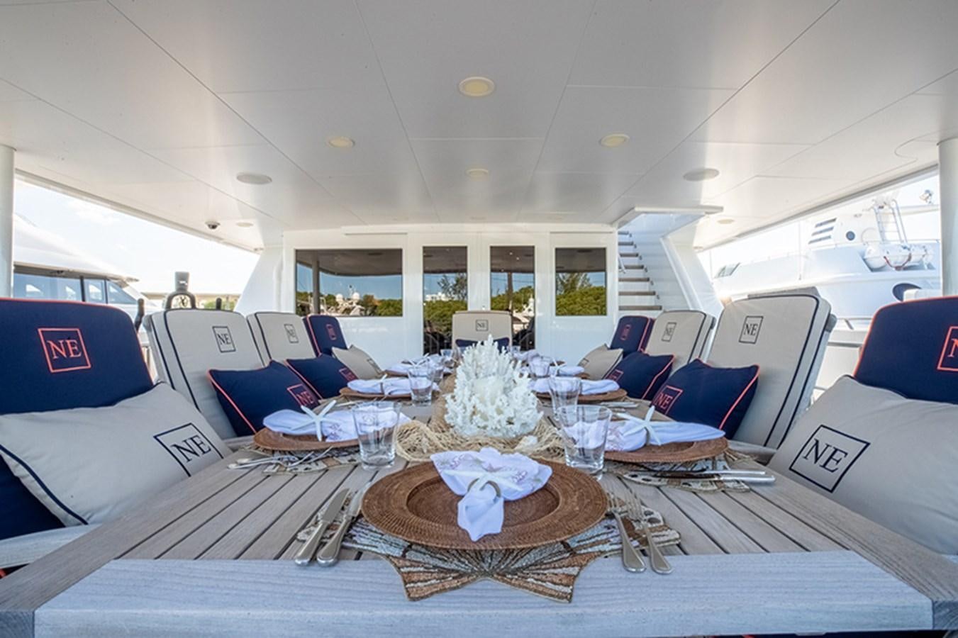 a large room with a table and chairs aboard NEVER ENOUGH Yacht for Sale
