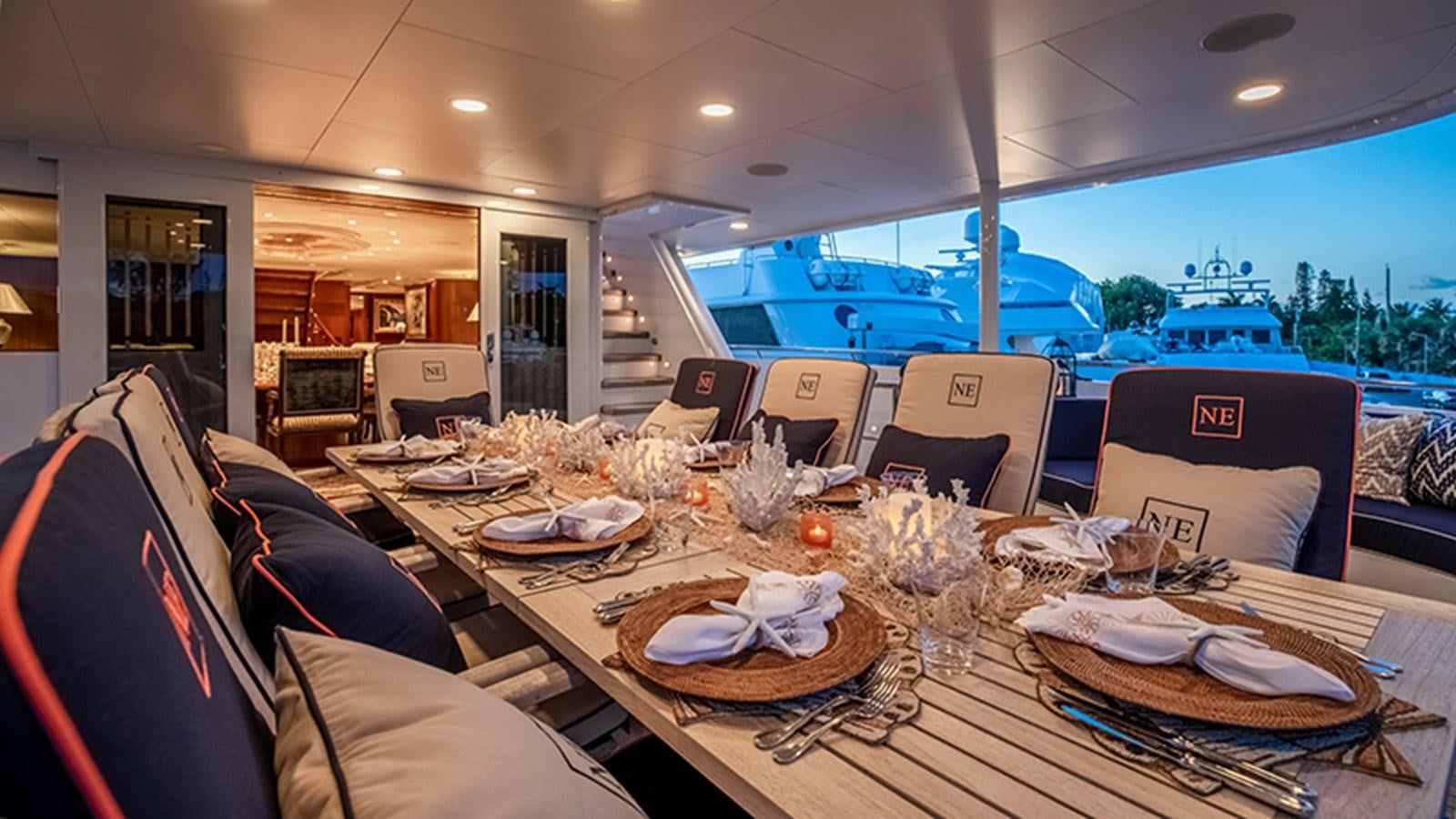 a dining table with plates and chairs aboard NEVER ENOUGH Yacht for Sale