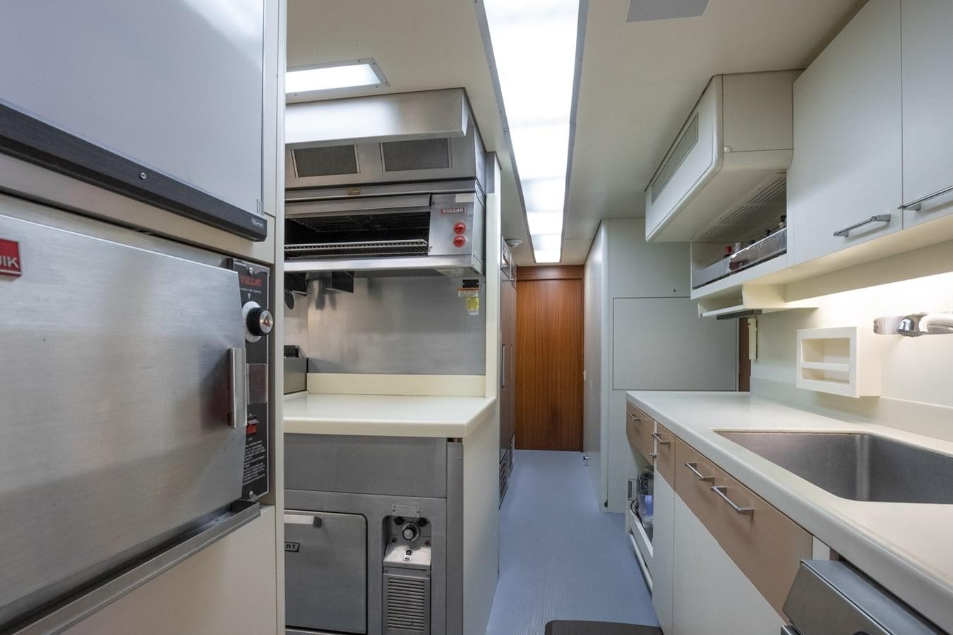 a kitchen with a stainless steel oven aboard NEVER ENOUGH Yacht for Sale