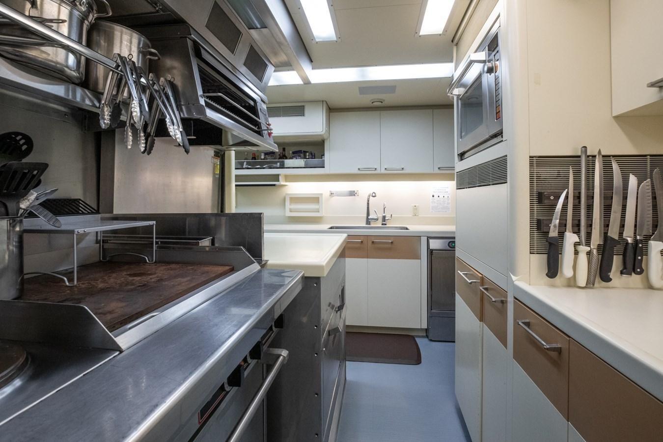 a kitchen with stainless steel appliances aboard NEVER ENOUGH Yacht for Sale