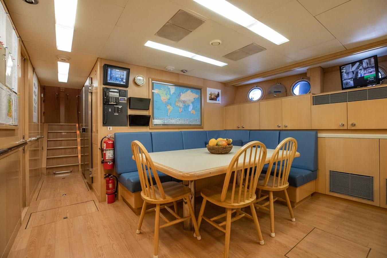 a room with a table and chairs aboard NEVER ENOUGH Yacht for Sale